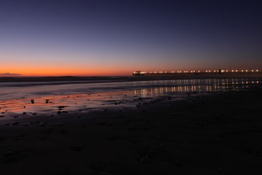 A picturesque view of the Oceanside Pier in California, illuminated by a stunning sunset