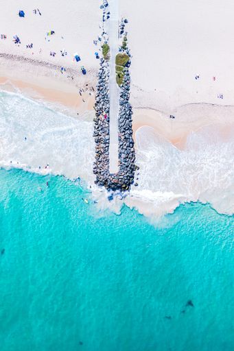 An aerial view of City Beach, Western Australia, showing a pier leading out into the ocean