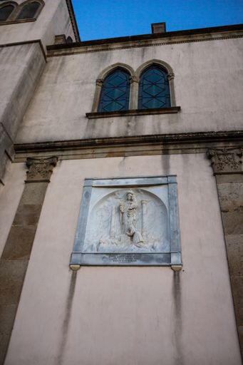 A marble relief sculpture and arch windows of Basilica Santa Maria Della Neve in Cuglieri, Italy