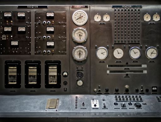 A closeup shot of details on a vintage nuclear power plant control panel