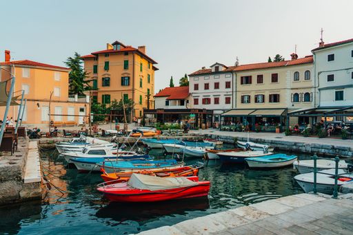Colorful houses and boats docked near a pier in Volosko, Opatija, Croatia