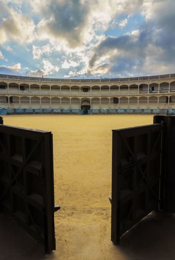 view of the bullring of ronda from behind the wooden entrance gates in ronda,malaga,spain on 11-30-2023