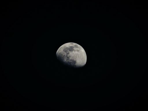 A closeup shot of the bright moon in the dark night sky
