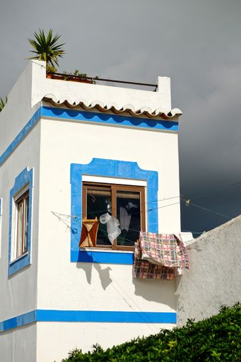 A vertical shot of rural houses in Cacela Velha in Algarve Portugal on a cloudy day