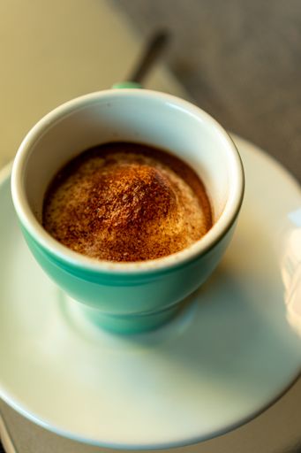 A vertical shot of a cup of espresso coffee