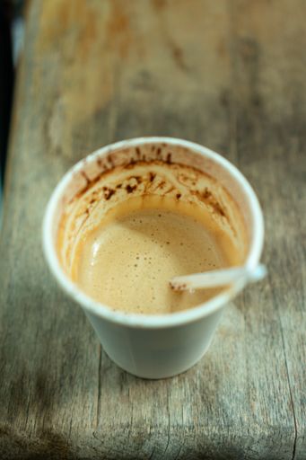 A vertical shot of coffee in a plastic cup