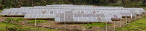 The rows of solar panels in a rural area