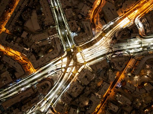 An aerial photograph of the city of Zurich, Switzerland at night covered in snow