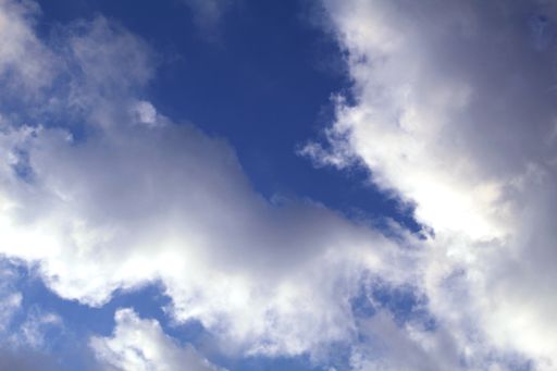 A low angle shot of the beautiful fluffy clouds in the blue sky