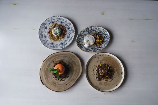 A top view of delicious decorated desserts in plates on the table in a restaurant