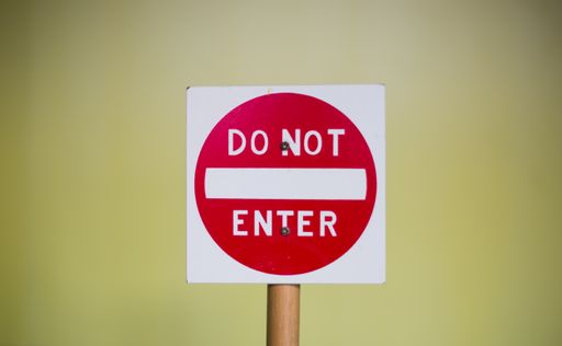 A closeup shot of a "Do not enter" sign on a blurred background
