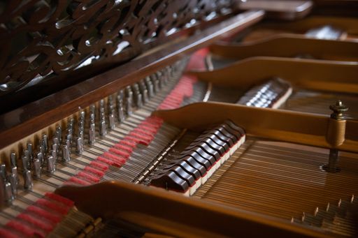 A closeup shot of a fortepiano with tiles