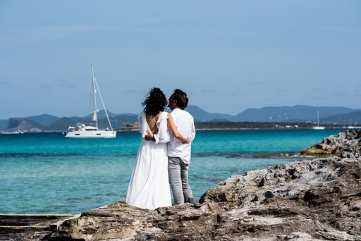 Formentera, Spain: 2021 My 26:  Couple on the coast of Ses Illetes beach in Formentera, Balearic Islands in Spain.