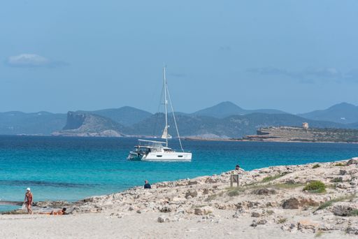 Formentera, Spain: 2021 My 26: Boats moored on the coast of Ses Illetes beach in Formentera, Balearic Islands in Spain.