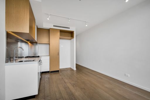 A kitchen with white and wooden furniture