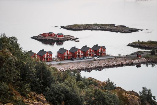 A breathtaking aerial view of Lofoten, Norway, featuring picturesque red houses