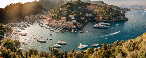 A picturesque view of small boats floating in a tranquil bay on a sunny day at a Mediterranean island