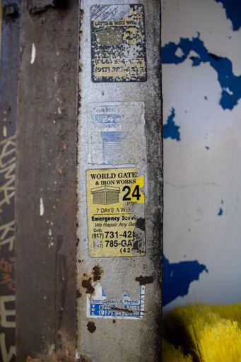 A fire hydrant is situated atop a bright yellow carpet, against a vivid blue wall backdrop