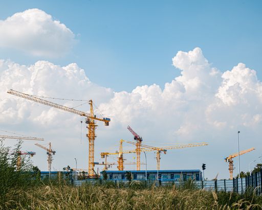 The large cranes atop a large industrial building under construction in Wuhan, China