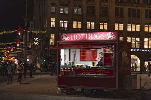 fast food kiosk in a city square in Amsterdam at night