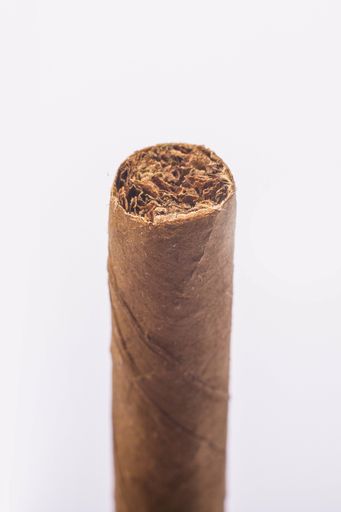 A vertical shot of an element of a cigar on an isolated background