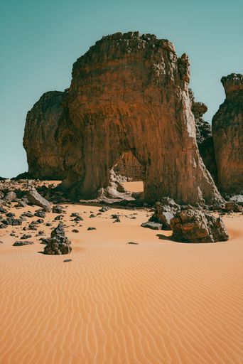 A picturesque scene of a barren desert landscape, featuring one lone mountain and numerous rocky outcroppings