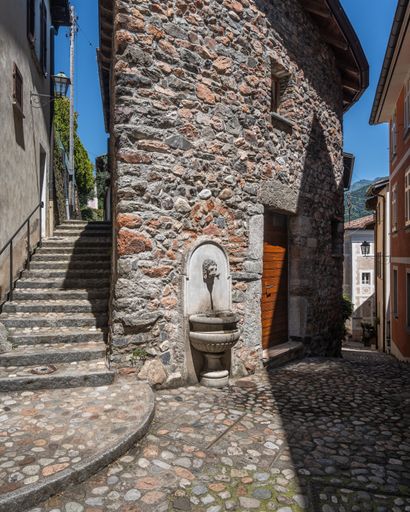 A picturesque view of the village of Morcote, Switzerland, with its traditional architecture and stunning mountain backdrop