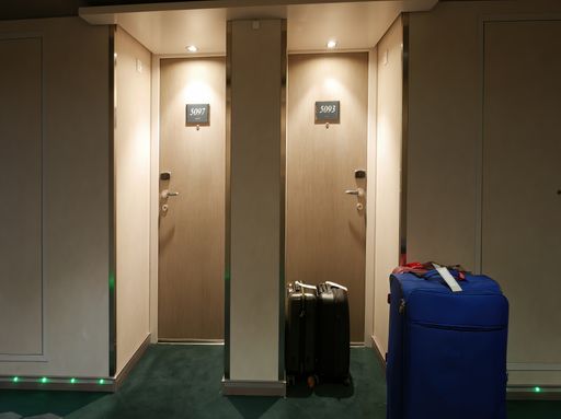 This image shows two empty restroom stalls in a vacant room