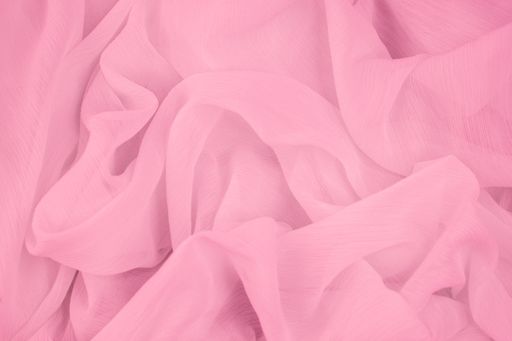 A closeup of a plain pink fabric texture