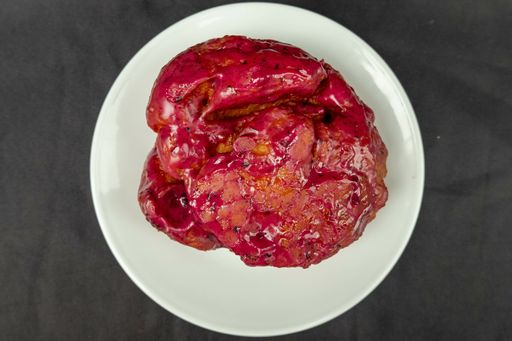 A top view of a delicious pie with raspberry jam on a black background