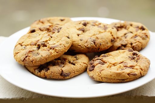 A selective focus shot of fresh home-made chocolate cookies on white plate
