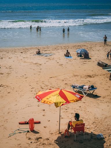 Lifeguard keeping watch on the beach at Olhos de Agua Algarve