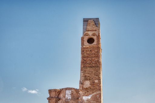 A square brick tower that looks like it has a face