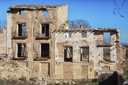 An old ruined building with windows during daytime