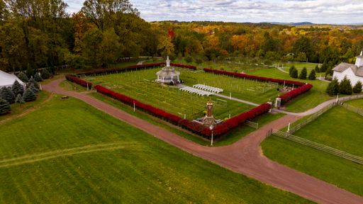 An Aerial View of a Large Gazebo in the Middle of a Vineyard, With Seating for a Weddings, and a Corner Fireplace, on an Autumn Day