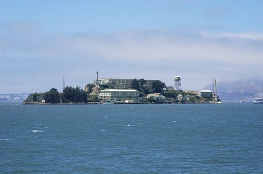 The sea surrounding the Golden Gate Bridge and buildings in San Francisco under the sunlight