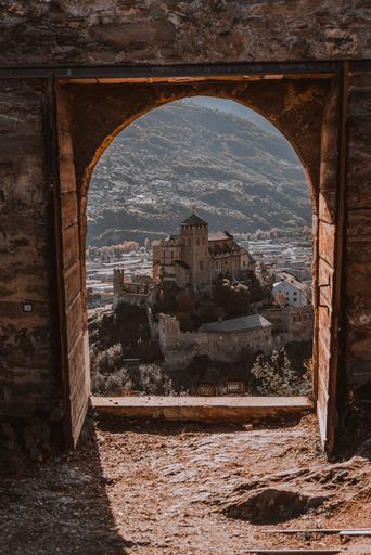 The View of Valere Basilica through a castle's outer door in Sion, Switzerland