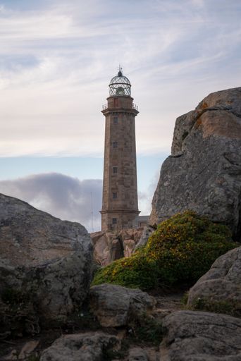 The Cape Vilan lighthouse in Galicia, Spain on the background of the cloudy sky