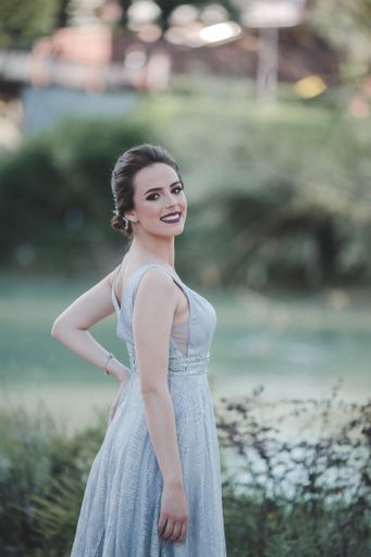 A shallow focus of an adult woman wearing a long gray dress in a park in Bosnia and Herzegovina