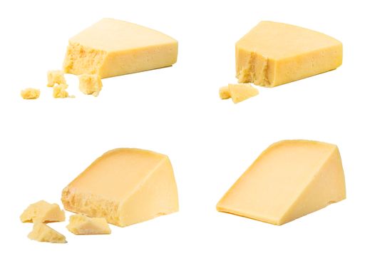 A closeup of parmesan cheese in pieces, on a white background