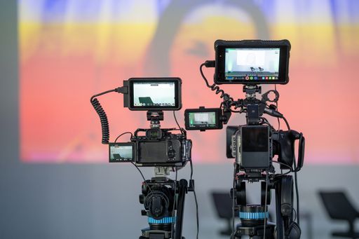 The two professional video cameras with the monitor in view.