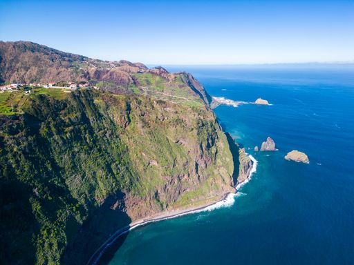An aerial view of a stunning coastal landscape, featuring cliffs and tranquil waters. Madeira, Portugal