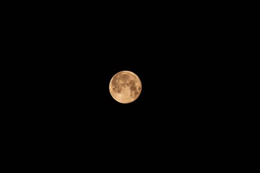 A mesmerizing view of a moon over the dark black sky at night