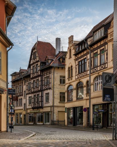 A cobblestone street with historic buildings in Quedlinburg, Germany