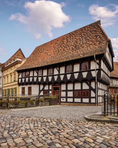 A cobblestone street in Quedlinburg with historical buildings