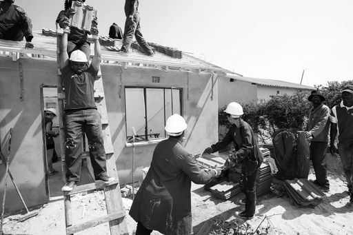Soweto, South Africa, September 10, 2011,  Diverse Community members building a low cost house as a team in Soweto
