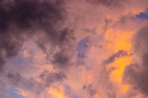 A beautiful blue sky with pink and purple cumulus clouds during sunset