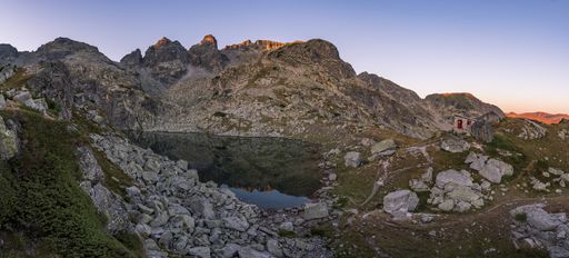 A high angle shot of a small lake at the Rila mountain, Bulgaria with the beautiful sky behind