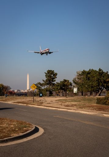 An American Airlines 737 with retro livery flying over Washington Monument prior to landing at Ronald Reagan Airport