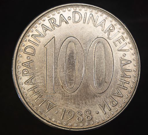 A closeup shot of a Yugoslavian dinar coin on a black background.